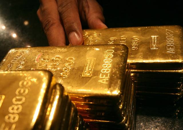 Gold falls to over 1-week low as dollar holds