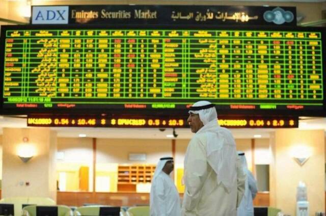 متداولون يتابعون أداء الأسهم بسوق أبوظبي للأوراق المالية
