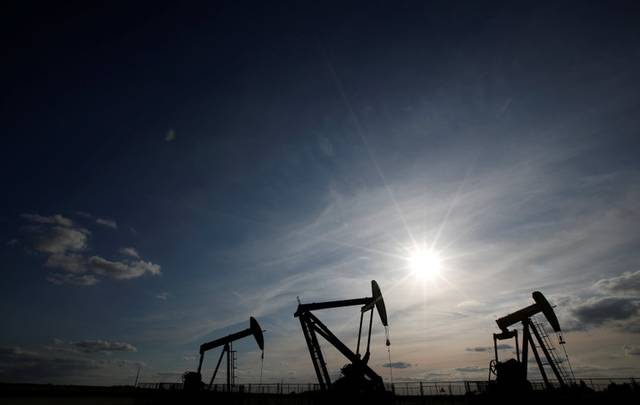 Oil edges up on output curbs; global slowdown caps gains
