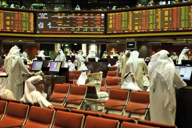 متعاملون بسوق الكويت يتابعون أسعار الأسهم - الصورة من رويترز أريبيان آي